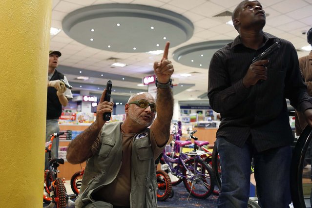 Security officers secure an area inside the Westgate Shopping Centre. (Photo by Siegfried Modola/Reuters)