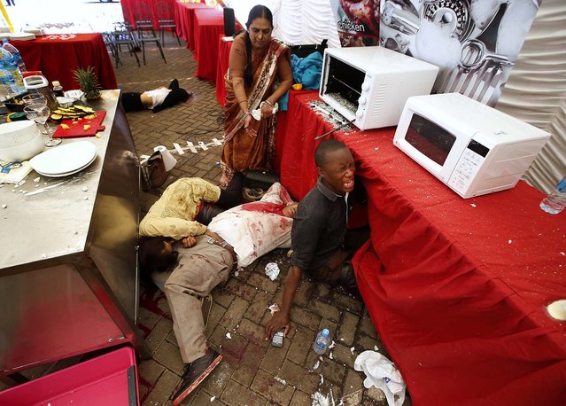 Injured people cry for help inside the mall. (Photo by Goran Tomasevic/Reuters)